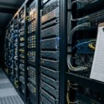 Patch management under pressure, shown by an unfinished checklist beside live server racks