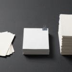 Three stacks of paper of very different heights, illustrating uneven AI Overviews traffic impact across publisher sizes